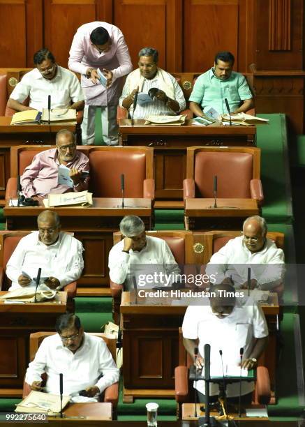 Former Chief Minister of Karnataka, Siddaramaiah discusses state budget with an another MLA while Chief Minister of Karnataka, H D Kumaraswamy...