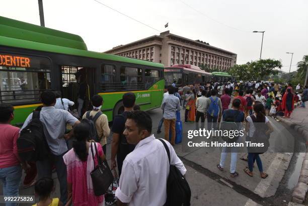 People catch bus for Badarpur outside Central Secratariat Metro station after temporary shutdown of Delhi Metro's Violet Line, on July 5, 2018 in New...