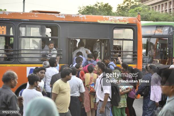 People catch bus for Badarpur outside Central Secratariat Metro station after temporary shutdown of Delhi Metro's Violet Line, on July 5, 2018 in New...