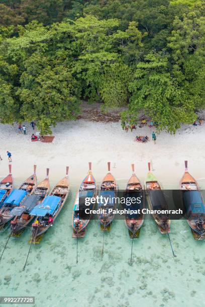 aerial view over group of long tail boats with beautiful sea and beachtop view from drone koh lipe island, satun province, thailand. - ko lipe stock pictures, royalty-free photos & images