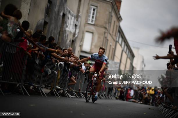 Spectators cheer as Germany's Marcel Kittel of Switzerland's Katusha Alpecin cycling team cycles past during the team presentation ceremony on July...