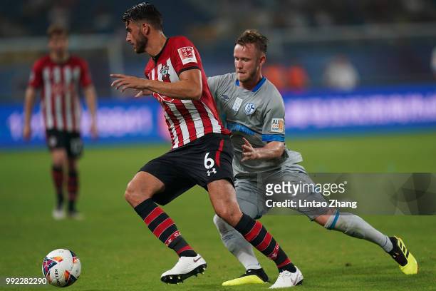 Cedric Teuchet of Schalke FC competes the ball with Wesley Hoedt of Southampton FC during the 2018 Clubs Super Cup match between Schalke and...