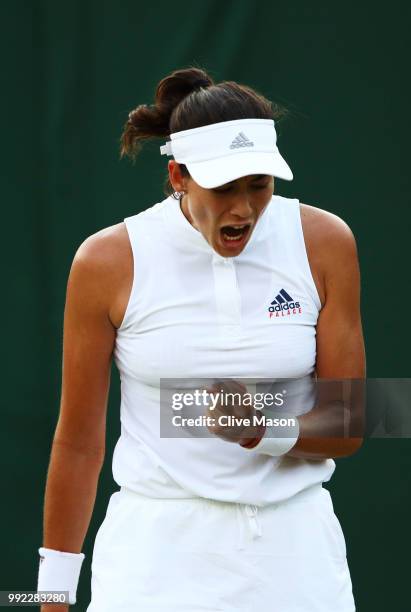 Garbine Muguruza of Spain celebrates a point against Alison Van Uytvanck of Belgium during their Ladies' Singles second round match on day four of...