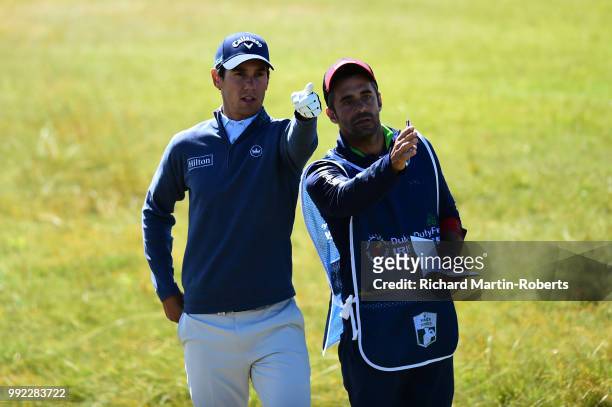 Matteo Manassero of Italy gestures with his caddie on the 18th hole during the first round of the Dubai Duty Free Irish Open at Balllyliffin Golf...