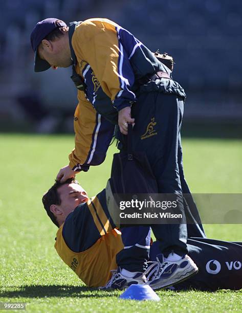 Joe Roff of Australia is patted on the head by Greg Craig of Australia after getting over a ankle injury during the Wallabies last training session...