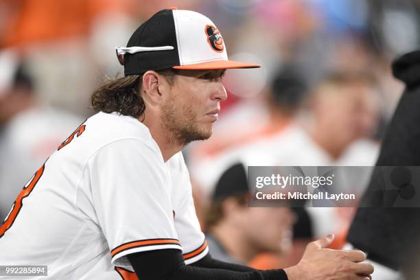 Colby Rasmus of the Baltimore Orioles looks on form the dug out during a baseball game against the Seattle Mariners at Oriole Park at Camden Yards on...
