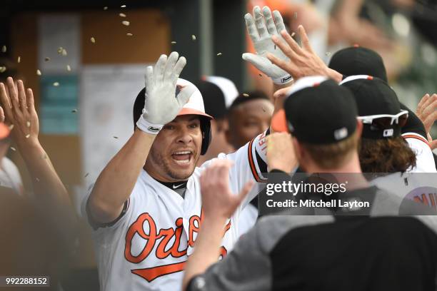 Danny Valencia of the Baltimore Orioles celebrates scoring a run during a baseball game against the Seattle Mariners at Oriole Park at Camden Yards...