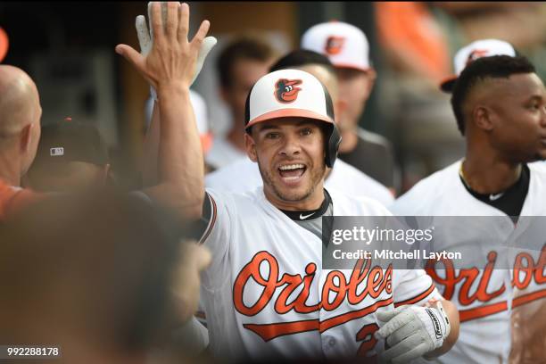 Danny Valencia of the Baltimore Orioles celebrates scoring a run during a baseball game against the Seattle Mariners at Oriole Park at Camden Yards...