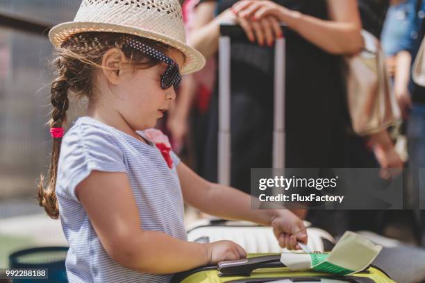 lovely toddler girl with sunglasses waiting in line to board a plane - coffer stock pictures, royalty-free photos & images