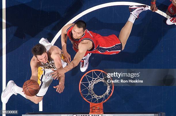 Josh McRoberts of the Indiana Pacers goes to the basket against Yi Jianlian of the New Jersey Nets during the game at Conseco Fieldhouse on April 10,...