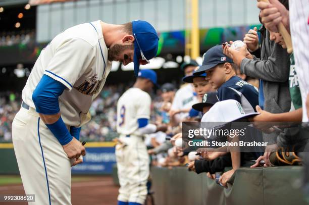 Mitch Haniger, of the Seattle Mariners and Dee Gordon of the Seattle Mariners sign autographs for fans before a game against the Kansas City Royals...