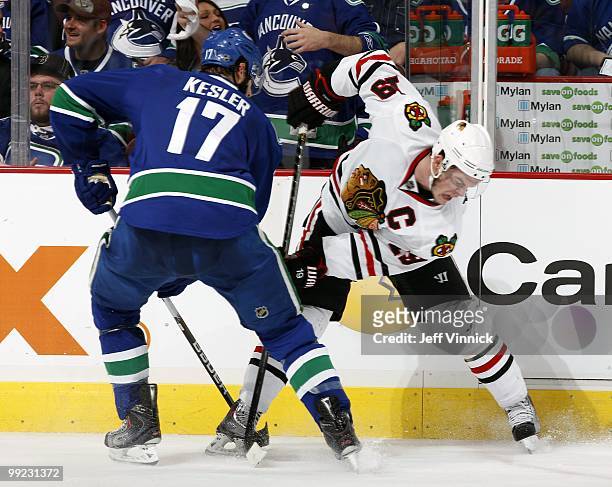 Ryan Kesler of the Vancouver Canucks and Jonathan Toews of the Chicago Blackhawks look for a loose puck in Game 6 of the Western Conference...