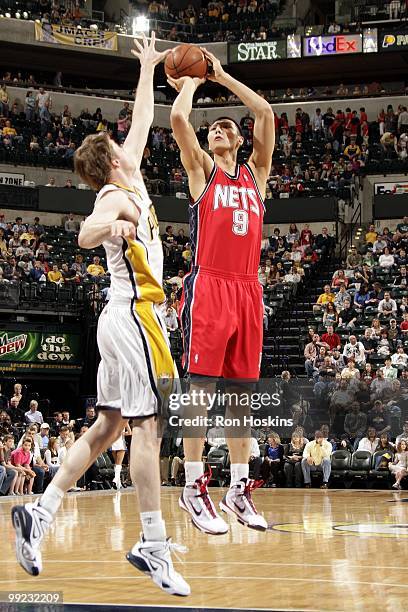 Yi Jianlian of the New Jersey Nets shoots a jump shot against Troy Murphy of the Indiana Pacers during the game at Conseco Fieldhouse on April 10,...