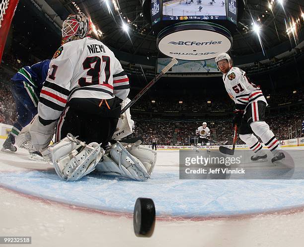 Antti Niemi and Brian Campbell of the Chicago Blackhawks watch a Canuck shot get into the net in Game 6 of the Western Conference Semifinals against...