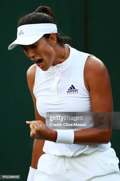 Garbine Muguruza of Spain celebrates a point against Alison Van Uytvanck of Belgium during their Ladies' Singles second round match on day four of...