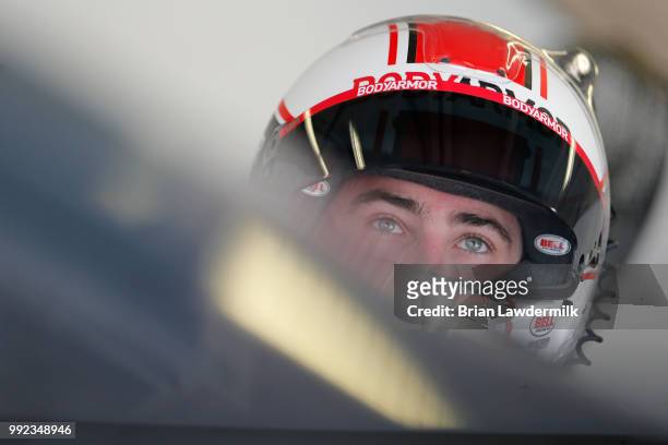 Ryan Blaney, driver of the BodyArmor Ford, gets into his car during practice for the NASCAR Xfinity Series Coca-Cola Firecracker 250 at Daytona...