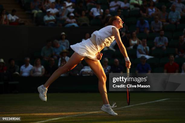 Alison Van Uytvanck of Belgium serves against Garbine Muguruza of Spain during their Ladies' Singles second round match on day four of the Wimbledon...