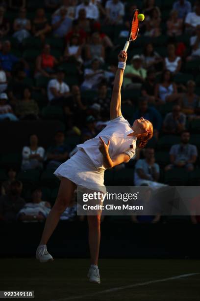 Alison Van Uytvanck of Belgium serves against Garbine Muguruza of Spain during their Ladies' Singles second round match on day four of the Wimbledon...