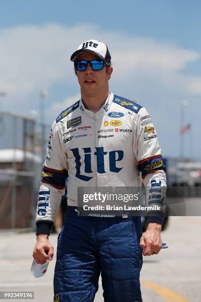 Brad Keselowski, driver of the Stars Stripes and Lites Ford, walks to his car during practice for the Monster Energy NASCAR Cup Series Coke Zero...