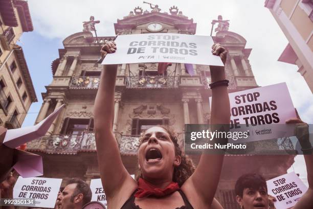 Protester against animal cruelty in bull fightings before San Fermin celebrations shouts under the Pamplona city council building, Spain.