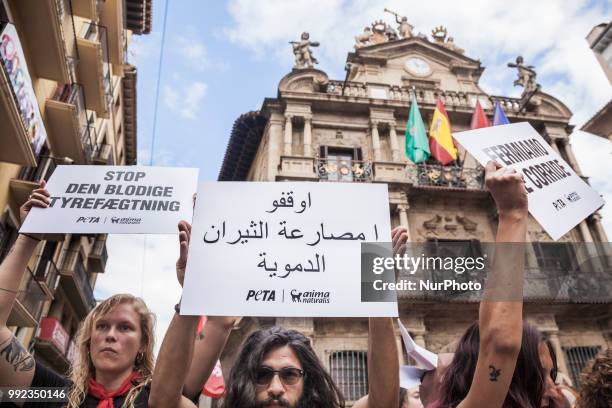 Protest against animal cruelty in bull fightings before San Fermin celebrations in Pamplona, Spain. Banner says &quot;stop bullfightings&quot;.