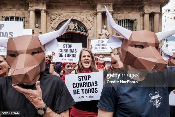 Protest against animal cruelty in bull fightings before San Fermin celebrations in Pamplona, Spain. Banner says &quot;stop bullfightings&quot; and...