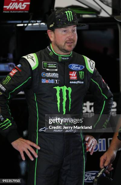 Kurt Busch, driver of the Monster Energy/Haas Automation Ford, stands in the garage area during practice for the Monster Energy NASCAR Cup Series...