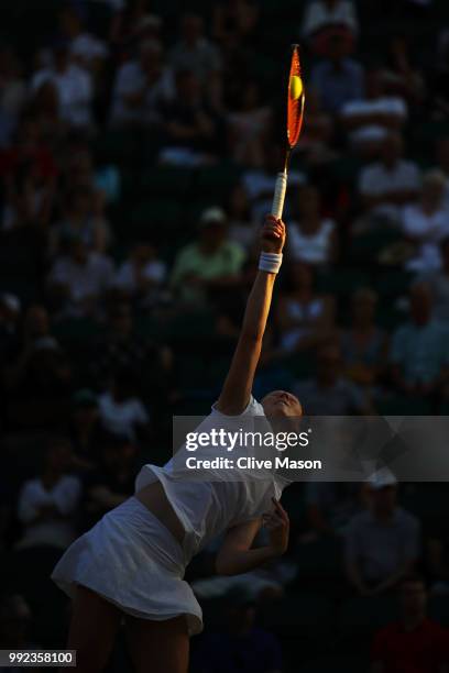 Alison Van Uytvanck of Belgium serves against Garbine Muguruza of Spain during their Ladies' Singles second round match on day four of the Wimbledon...