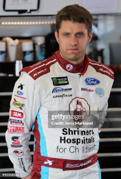 David Ragan, driver of the Shriners Hospital For Children Ford, stands in the garage during practice for the Monster Energy NASCAR Cup Series Coke...