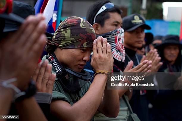 Anti-government Black Shirt Guards pray at a shrine on May 13, 2010 in central Bangkok, Thailand. The Black Shirt Guards are used as security forces...