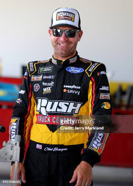 Clint Bowyer, driver of the Rush Truck Centers Ford, stands in the garage area during practice for the Monster Energy NASCAR Cup Series Coke Zero...
