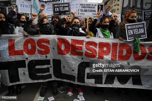 Workers of state-owned news agency Telam and colleagues demonstrate in Buenos Aires on July 5, 2018 against a mass layoff in the agency and demand...
