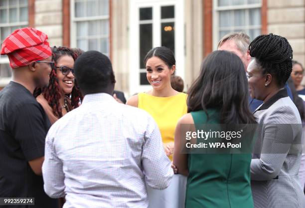 Meghan, Duchess of Sussex meets guests during the Your Commonwealth Youth Challenge reception at Marlborough House on July 05, 2018 in London,...