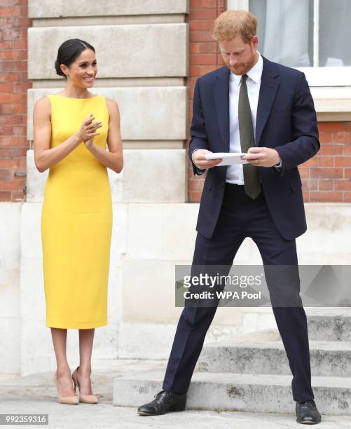 Meghan, Duchess of Sussex applauds her husband Prince Harry, Duke of Sussex after his speech during the Your Commonwealth Youth Challenge reception...