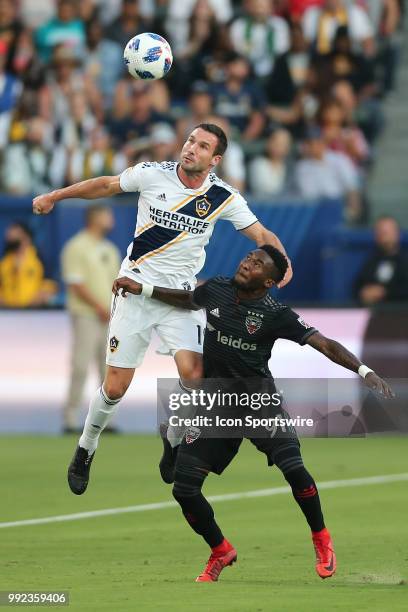 Los Angeles Galaxy forward Chris Pontius and D.C. United midfielder Oniel Fisher battle for the lob pass in the game between the D.C. United and the...