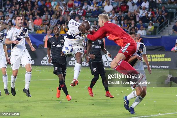 Los Angeles Galaxy defender Michael Ciani and D.C. United goalkeeper David Ousted collide in the box as Ciani tried to head the ball in goal in the...