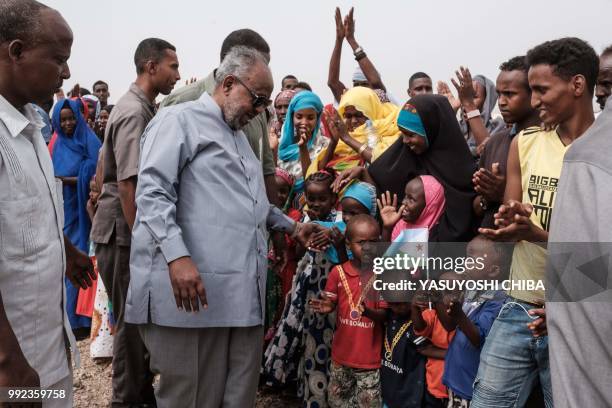 Djibouti's President Ismail Omar Guelleh greets people before the launching ceremony of new 1000-unit housing contruction project in Djibouti, on...