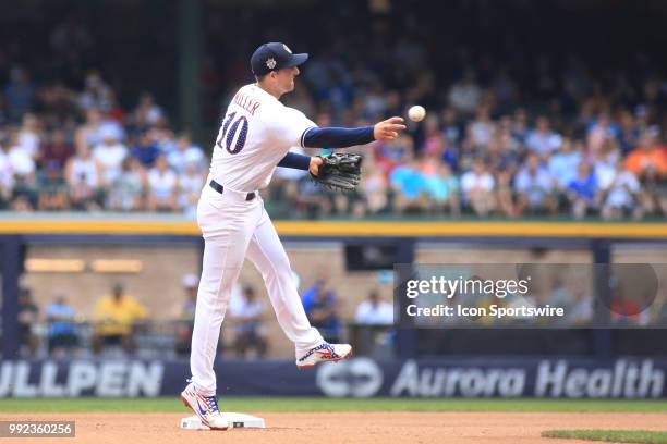 Milwaukee Brewers second baseman Brad Miller throws to first during a game between the Milwaukee Brewers and the Minnesota Twins at Miller Park on...