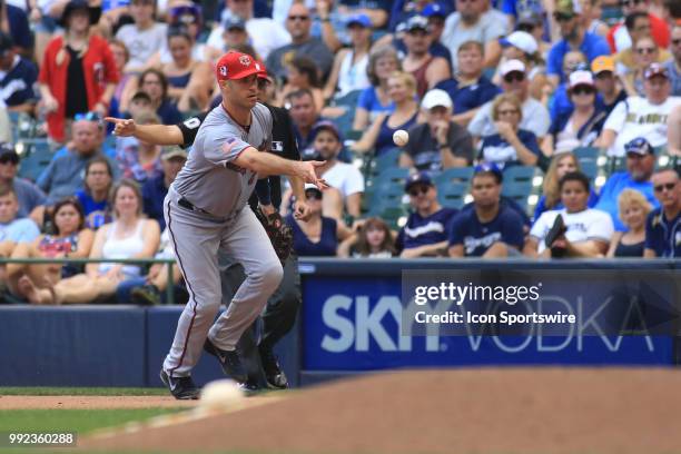 Milwaukee Brewers first baseman Eric Thames tosses to first base during a game between the Milwaukee Brewers and the Minnesota Twins at Miller Park...