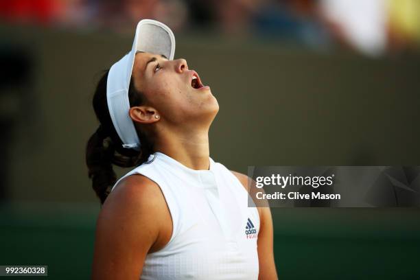 Garbine Muguruza of Spain reacts against Alison Van Uytvanck of Belgium during their Ladies' Singles second round match on day four of the Wimbledon...