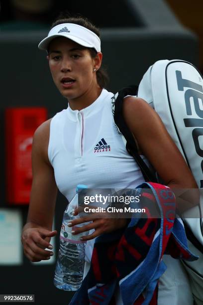 Garbine Muguruza of Spain walks off court after being defeated by Alison Van Uytvanck of Belgium in their Ladies' Singles second round match on day...