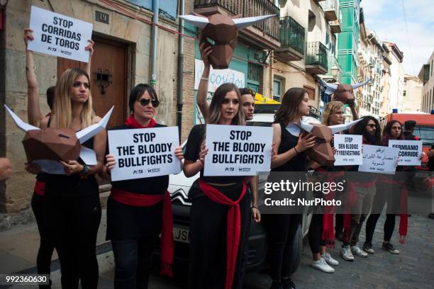 Members of the PETA collective carry signs with the slogan &quot;Stop bullfighting&quot; during their protest in the Plaza del Ayuntamiento in...