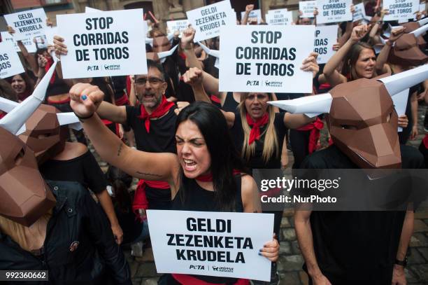 Members of the PETA collective carry banners with the slogan &quot;Stop bullfighting&quot; during their protest in the town hall of Pamplona for the...