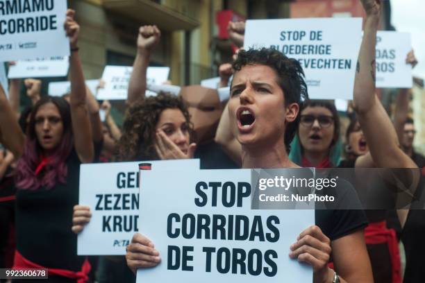 Young girl from the PETA collective shouts anti-bullfighting slogans during her protest in the Plaza del Ayuntamiento in Pamplona on the occasion of...