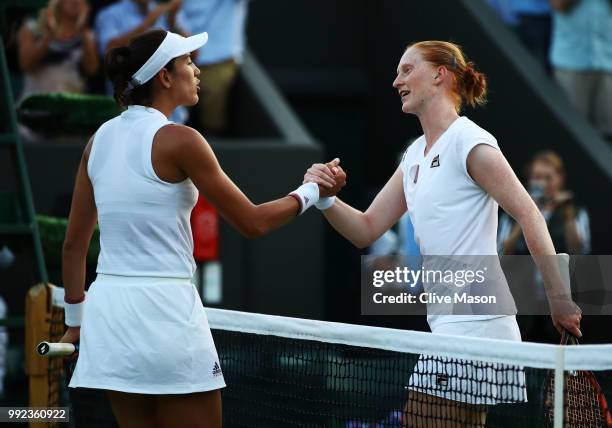 Alison Van Uytvanck of Belgium shakes hands with Garbine Muguruza of Spain in their Ladies' Singles second round match on day four of the Wimbledon...