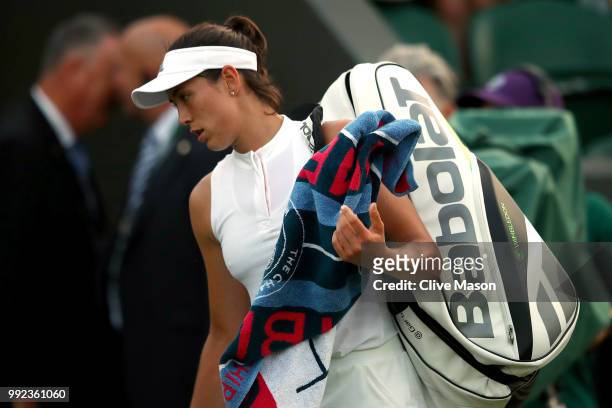 Garbine Muguruza of Spain walks off court after being defeated by Alison Van Uytvanck of Belgium in their Ladies' Singles second round match on day...