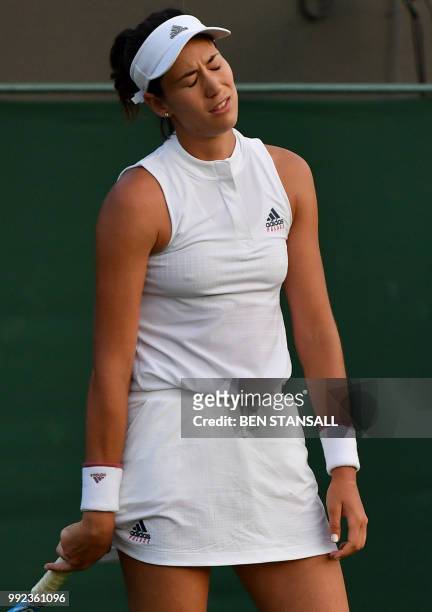 Spain's Garbine Muguruza reacts against Belgium's Alison Van Uytvanck during their women's singles second round match on the fourth day of the 2018...