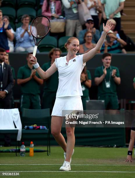 Alison Van Uytvanck acknowledges the crowd after beating Garbine Muguruza on day four of the Wimbledon Championships at the All England Lawn Tennis...