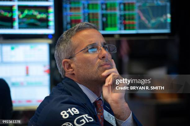 Traders work on the floor at the closing bell of the Dow Industrial Average at the New York Stock Exchange on July 5, 2018 in New York.