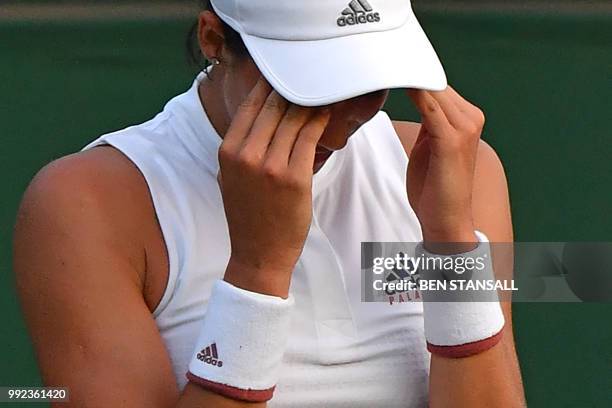 Spain's Garbine Muguruza reacts against Belgium's Alison Van Uytvanck during their women's singles second round match on the fourth day of the 2018...